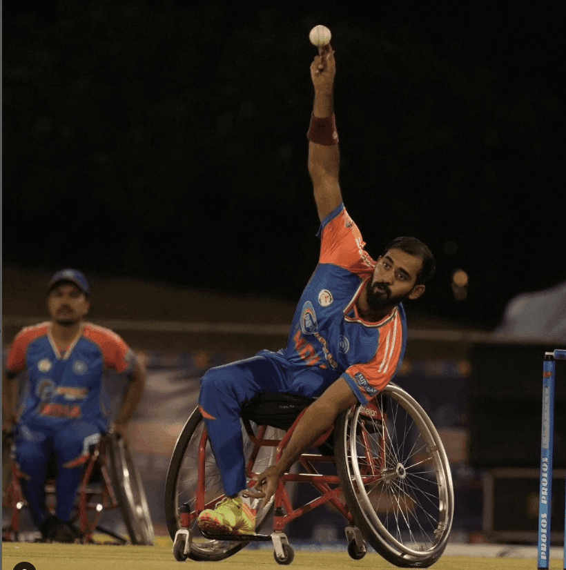 Wheelchair cricket bowling action shot