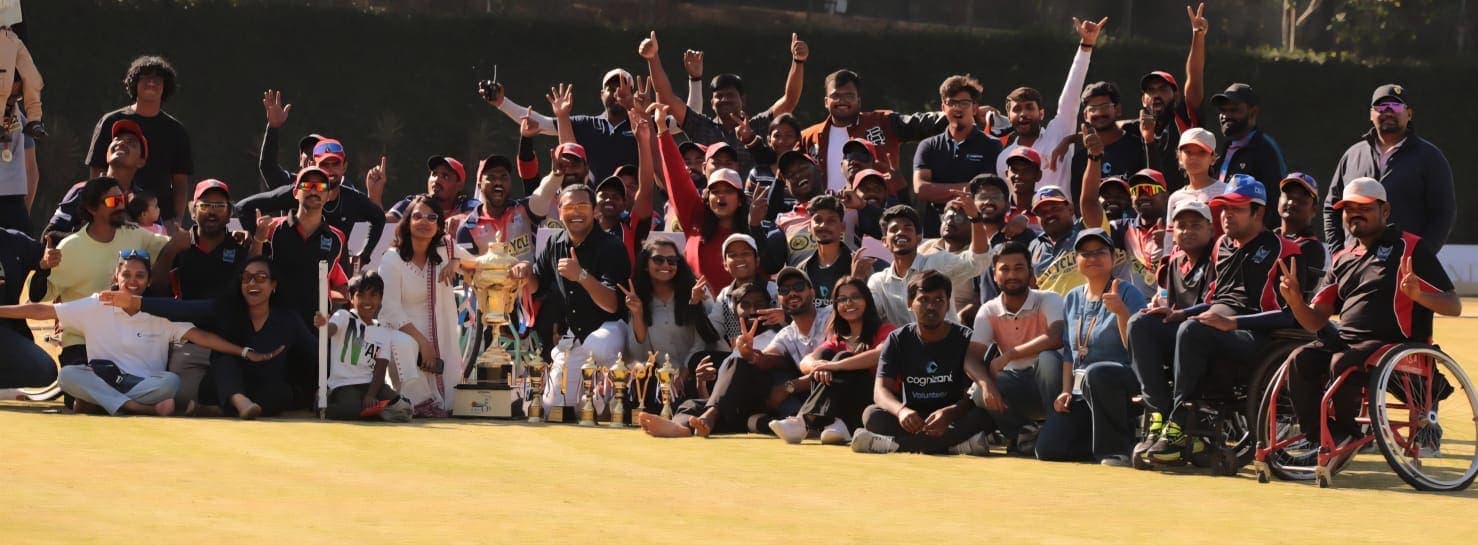 Volunteers, athletes and officials celebrating together with trophies at the end of a tournament